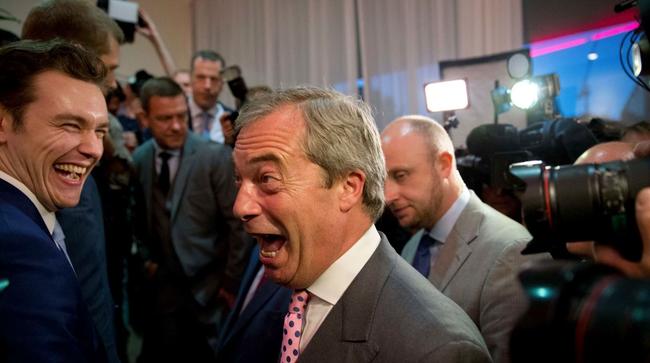 Nigel Farage, center, the leader of the UK Independence Party reacts in celebration at a "Leave.EU" organization party for the British European Union membership referendum in London, Friday, June 24, 2016. Source AAP