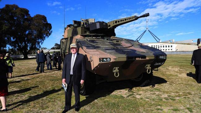Queenslander Senator Ian Macdonald with the Boxer vehicle. The Queensland bloc of federal LNP MPs and Senators, together with Rheinmetall Defence Australia, is stepping up the battle to win Queensland the $5 billion Land 400 Phase 2 defence contract to build 225 Combat Reconnaissance Vehicles.picture Gary Ramage. Picture: Gary Ramage