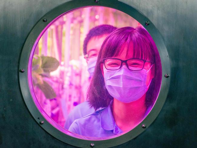 Student volunteers are seen inside the Lunar Palace 1, a laboratory simulating a lunar-like environment, as they prepare to leave the site in Beijing on May 15, 2018.