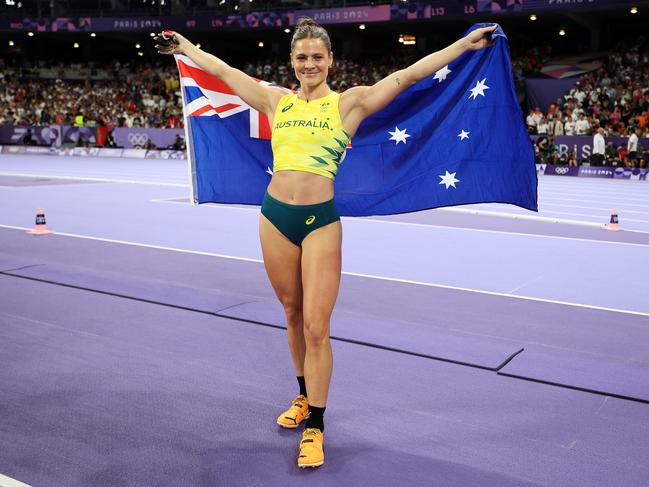 PARIS, FRANCE - AUGUST 07: Nina Kennedy of Team Australia celebrates winning the gold medal after competing in the Women's Pole Vault Final on day twelve of the Olympic Games Paris 2024 at Stade de France on August 07, 2024 in Paris, France. (Photo by Cameron Spencer/Getty Images)