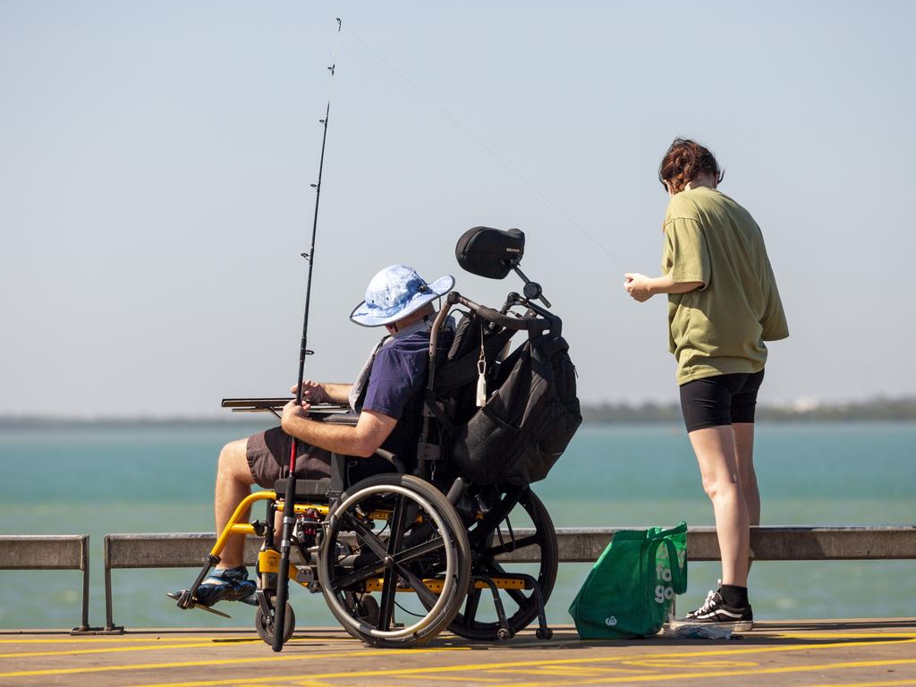 Jim Simpson and his carer Shalee Muller enjoying the 'perfect' cool weather for fishing at Stokes Hill Wharf on Monday morning. Picture: Floss Adams.