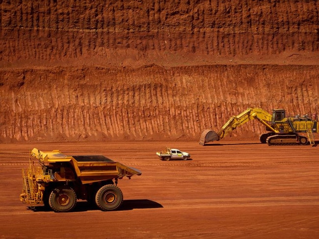 FILE PHOTO: Machinery operates in a pit at Rio Tinto Group's West Angelas iron ore mine in Pilbara, Australia, on Sunday, Feb. 19, 2012. Rio Tinto Group said Chief Executive Officer Tom Albanese will step down, after announcing a surprise $14 billion impairment. Sam Walsh, head of the iron-ore division, has been appointed as his successor with effect from today, the company said in a statement. Photographer: Ian Waldie/Bloomberg via Getty Images