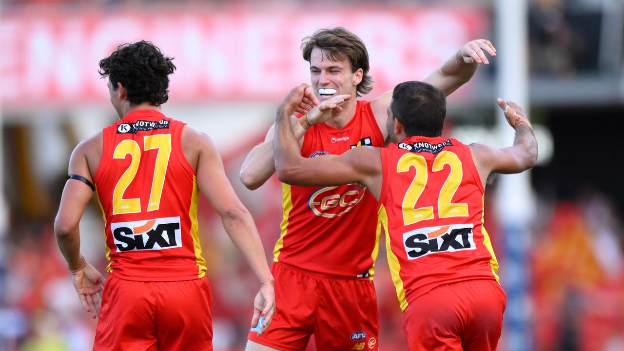 Charlie Ballard (centre) celebrates with his Gold Coast teammates. Picture: Matt Roberts/AFL Photos/Getty Images