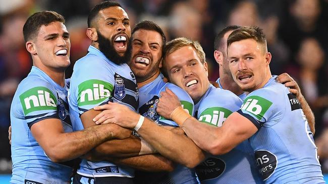 MELBOURNE, AUSTRALIA - JUNE 06:  Jake Trbojevic of the Blues is congratulated by team mates after scoring a try during game one of the State Of Origin series between the Queensland Maroons and the New South Wales Blues at the Melbourne Cricket Ground on June 6, 2018 in Melbourne, Australia.  (Photo by Quinn Rooney/Getty Images)