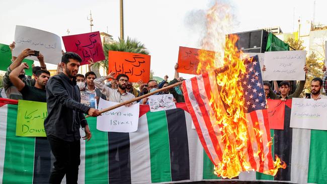 An Iranian student from the Islamic Basiji volunteer militia burns a US flag in the capital Tehran. Picture: AFP.