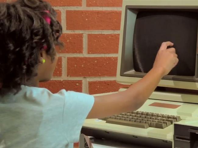 That’s not going to work ... Brooke-Monae, eight, tries to turn the computer on by touching the screen. YouTube/TheFineBros