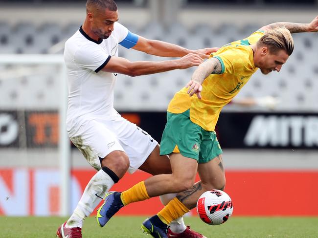 AUCKLAND, NEW ZEALAND - SEPTEMBER 25: Winston Reid, captain of New Zealand (L) tackles Jason Cummings of Australia during the International friendly match between the New Zealand All Whites and Australia Socceroos at Eden Park on September 25, 2022 in Auckland, New Zealand. (Photo by Fiona Goodall/Getty Images)