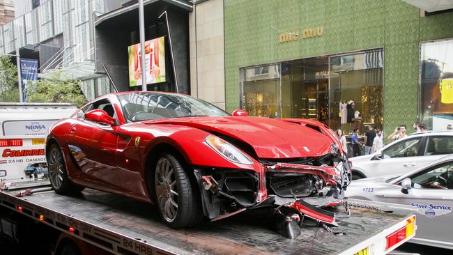 The crashed Ferrari is taken away from the scene. Picture: Tim Pascoe