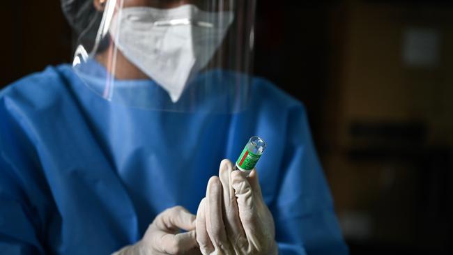 A health worker prepares coronavirus vaccine in Yangon, Maynamar. Only about 70 nations have started to vaccinate their populations. Picture: AFP