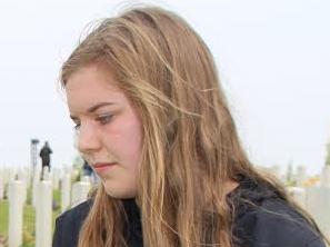 Megan Cridland from Maitland in NSW at Villers Bretonneux in northern France yesterday where she turned 17 years old as she comes across the headstone of a relative ahead of Anzac Day. Picture: Charles Miranda