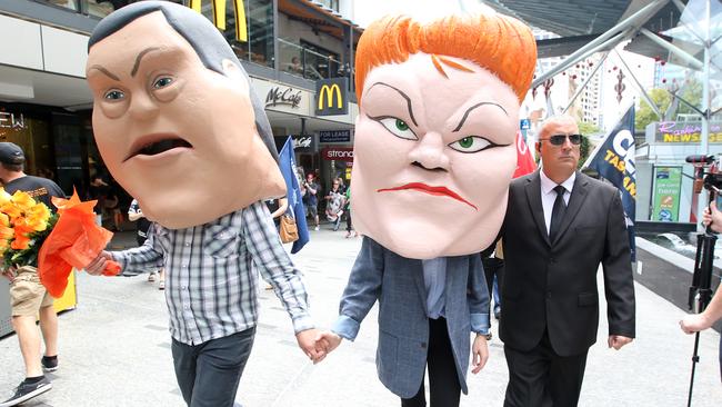 Protesters show Opposition Leader Tim Nicholls hand-in-hand with One Nation Leader Senator Pauline Hanson. Picture: AAP/Jono Searle