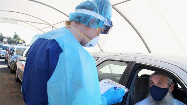 A nurse conducts a COVID-19 swab test. Picture: Lisa Maree Williams/Getty Images