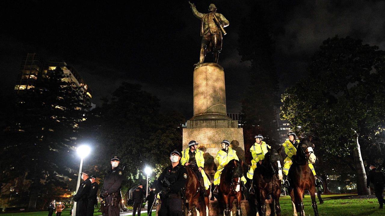 Police stand guard at the statue of Captain Cook in Hyde Park. Picture: Saeed Khan/AFP