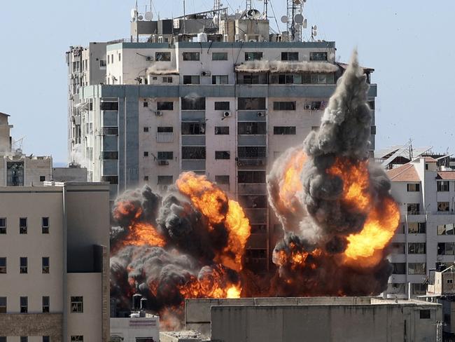 A ball of fire erupts from the Jala Tower as it is destroyed in an Israeli air strike. Picture: Mahmud Hams/AFP