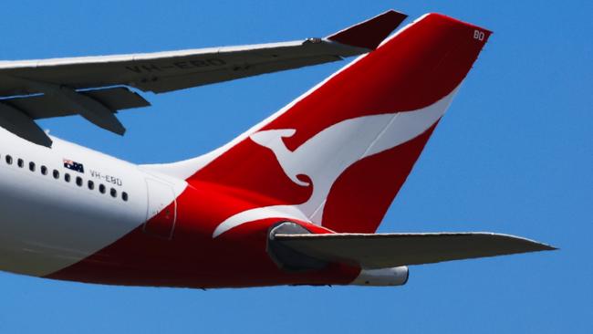 SYDNEY, AUSTRALIA - FEBRUARY 22: The tail of a Qantas plane is seen at take off from Sydney International Airport on February 22, 2024 in Sydney, Australia. Qantas has demonstrated a significant financial turnaround, reporting a record $2.47 billion profit for the 2022-23 fiscal year, marking a stark change from the previous year's $1.86 billion loss. The airline's strong performance was attributed to robust travel demand and high ticket prices, with domestic earnings before interest and taxes (EBIT) jumping to 18.2%, representing a 50% increase in profit margins over the past six years. The company's return on invested capital also increased to 103.6%, reflecting its improved financial position and operational performance. (Photo by Jenny Evans/Getty Images)