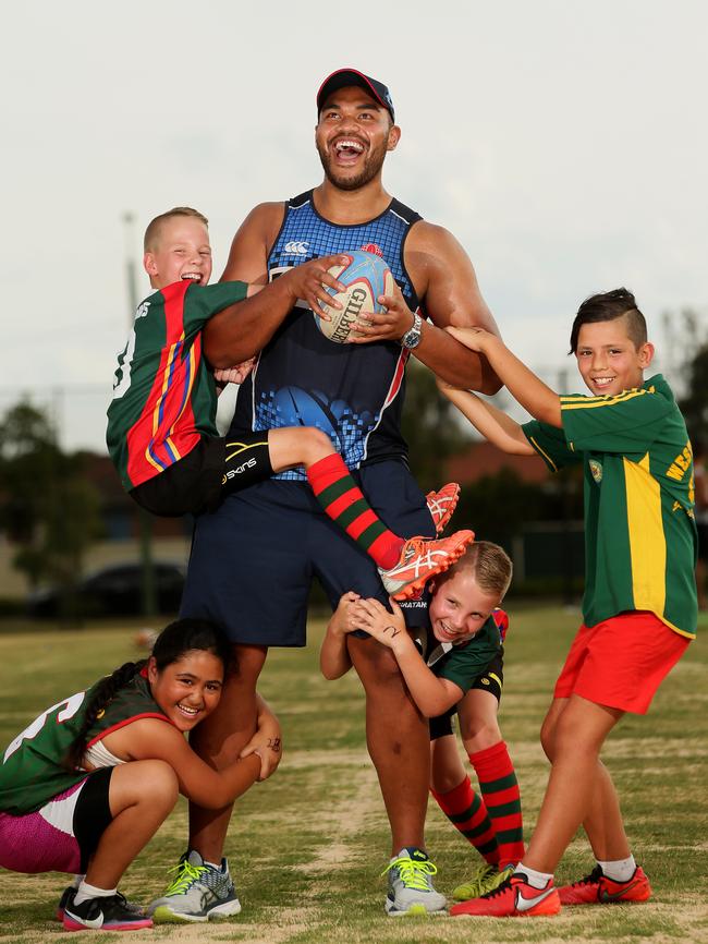 Senio Toleafoa of the Waratahs is tackled by Western Raptors Junior Rugby Union club players at Hassall Grove. Picture: Justin Sanson