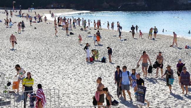 Beachgoers are moved on after the closure of Coogee Beach on Saturday. Picture: Gaye Gerard