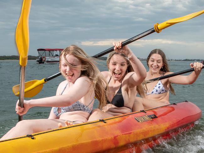 25-10-2021 Tourism businesses are stoked for the Ekka long weekend with positive booking signs with sunny weather on the cards. Paige Benstead, Katelyn Howe and Jayde Chandler enjoy the kayaks from BillÃs Boat Hire at Golden Beach. PICTURE: Brad Fleet