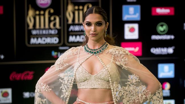 FILE - In this June 25, 2016 file photo, Bollywood actress Deepika Padukone poses for photographers at the International Indian Film Academy Rocks Green Carpet for the 17th Edition of IIFA Weekend & Awards in Madrid, Spain. A member of India's Hindu nationalist ruling party has offered a 100 million rupee ($1.5 million) reward to anyone who beheads the lead actress Padukone and  Sanjay Leela Bhansali, the director of the yet-to-be released Bollywood film "Padmavati" over its alleged handling of the relationship between a Hindu queen and a Muslim ruler.  The film's producers postponed the release of the film, which was set to be in theaters Dec. 1, 2017. (AP Photo/Samuel de Roman, File)