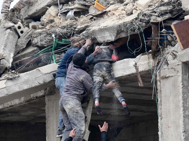 Residents retrieve an injured girl from the rubble of a collapsed building in the town of Jandaris, in the countryside of Syria's northwestern city of Afrin in the rebel-held part of Aleppo province. Picture: AFP