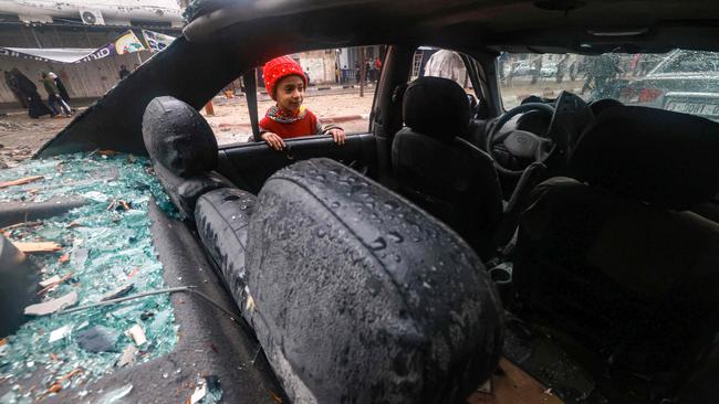A Palestinian boy looks inside a destroyed car in Rafah in the southern Gaza Strip. Picture: Mohammed Abed