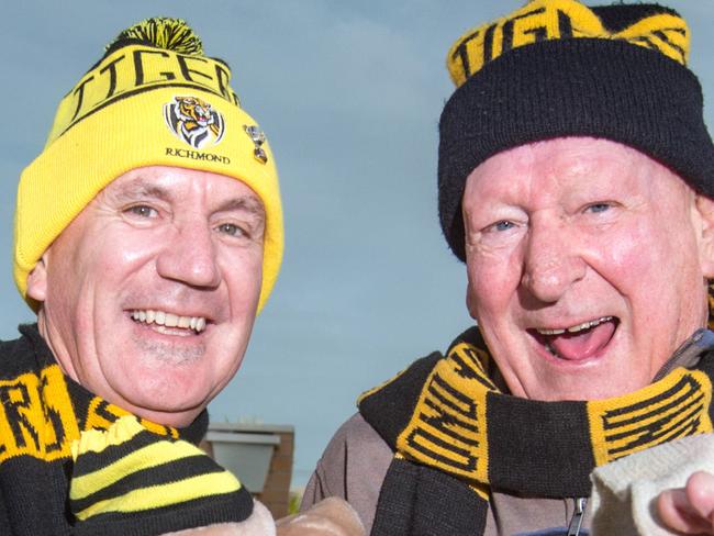 Neighbours Nick Murphy (L) and Peter Robinson (R) have struck up a ritual to celebrate Richmond FC wins. Nick puts a Trent Cotchin statue and flag in his window while Peter hangs a Tigers sock over his blinds in windows facing each others homes. They started as a tradition a number of years ago. Picture: Sarah Matray