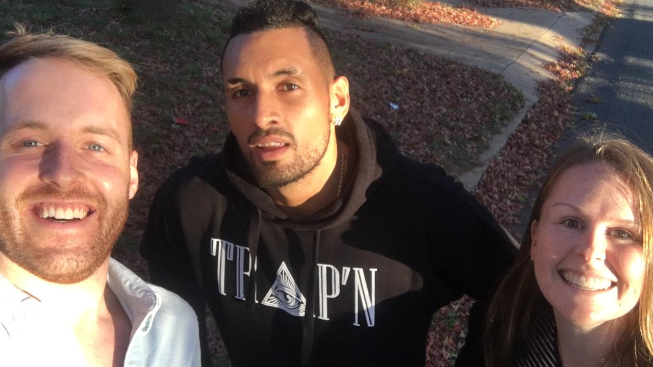 Nick Kyrgios poses for a selfie with the pair he helped.