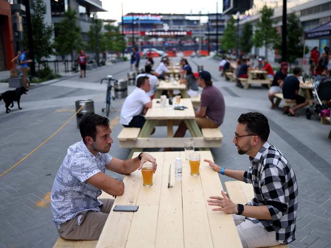 Baseball fans drink beer while gathering outside Nationals Park during the Opening Day game between the Washington Nationals and the New York Yankees on July 23. Picture: AFP