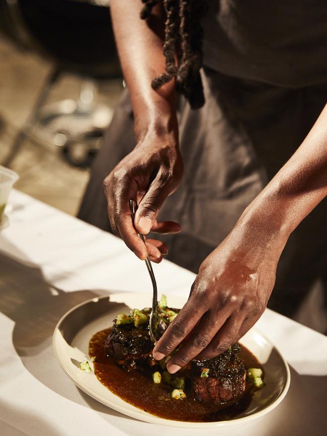 Paul Carmichael prepares Sunday night's al fresco welcome dinner at Qualia's Pebble Beach. Picture: Hamilton Island