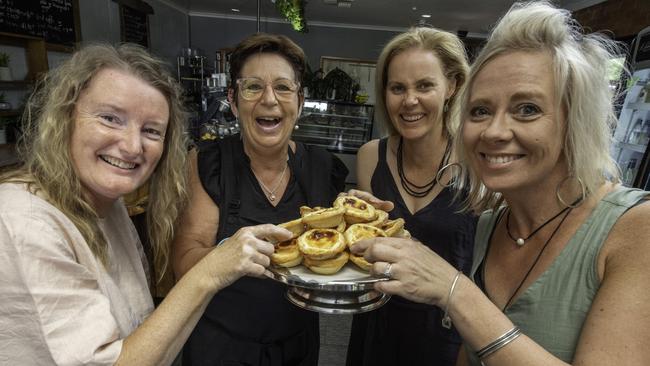 Seasons Cafe owner, in Mt Beauty Deb Lembke serving a customer Caroline, Lee and Monika in her cafe. Picture: Tony Gough