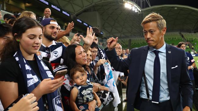 An injured Keisuke Honda signs autographs after the match between the Melbourne Victory and Wellington Phoenix last week. Picture: Getty Images