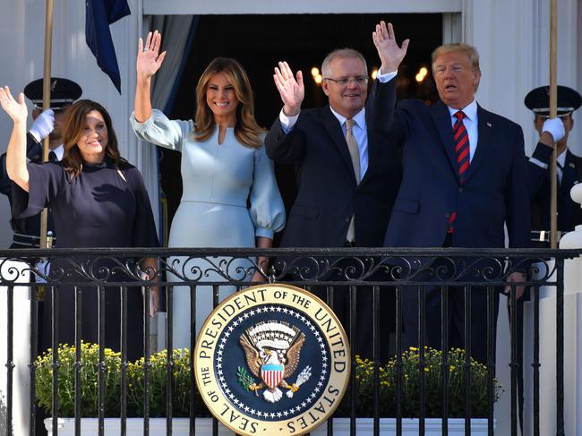 US President Donald Trump, First Lady Melania Trump, Australian Prime Minister Scott Morrison and his wife, Jenny Morrison waves from a balcony of the White House during an arrival ceremony. Picture: AFP