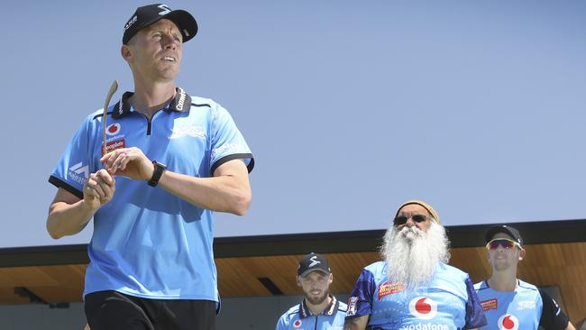 Striker Peter Siddle prepares to throw a boomerang under the watchful eye of ‘Uncle Moogy’ and teammates Phil Salt and Matt Short during the cultural awareness program the players undertook at Karen Rolton Oval on Wednesday. Picture: Dean Martin (AAP)