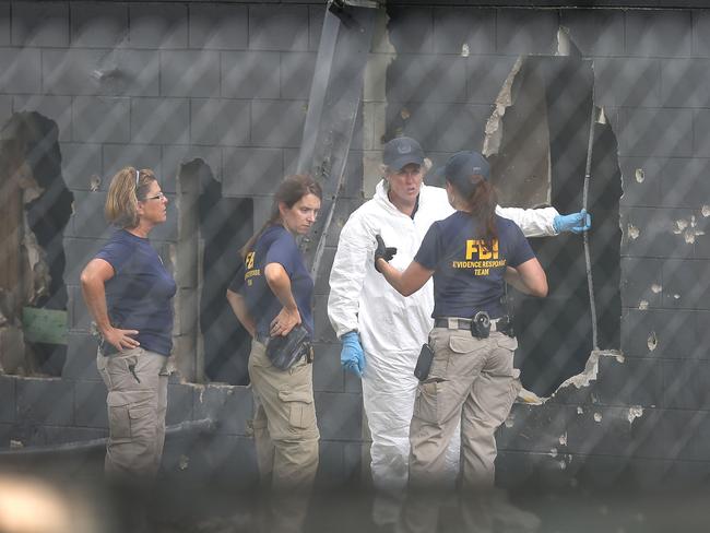 FBI agents investigate near the damaged rear wall of the Pulse nightclub, the scene of America’s worst mass shooting. Picture: Joe Raedle