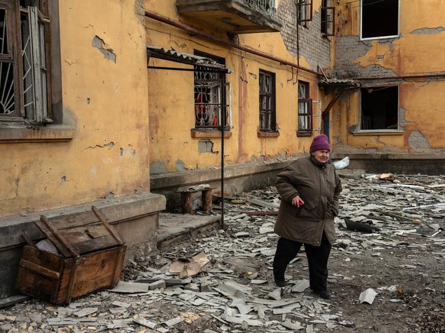 A woman walks through debris and rubble outside her apartment block after it was heavily damaged in a Russian attack in Kostyantynivka, Ukraine. Picture: Getty Images