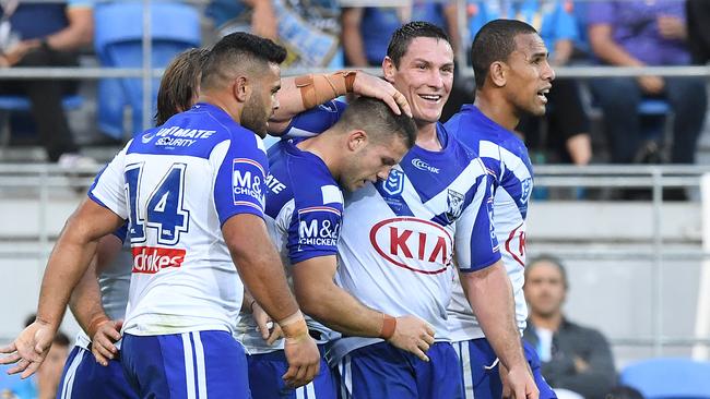 Bulldogs player Joshua Jackson (right) reacts with tryscorer Jack Cogger (centre). Picture: AAP Image/Dave Hunt