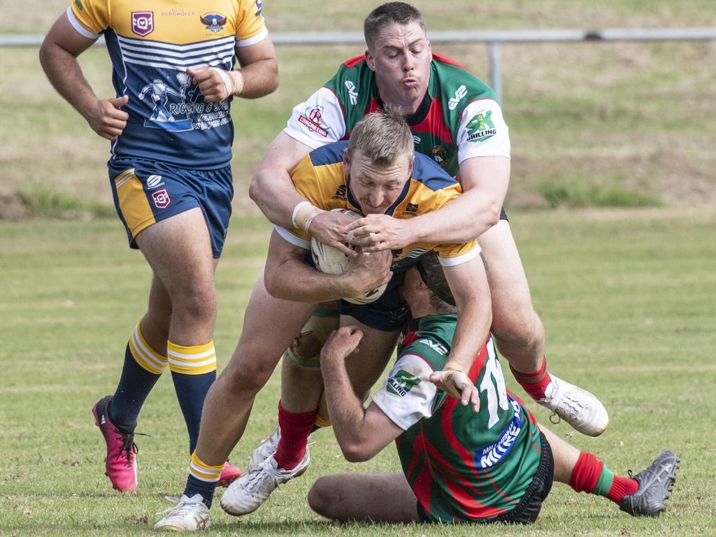 Highfields’ Carl Clement is tackled by Nicholas Nairn and Cameron Millar of Pittsworth. Picture: Nev Madsen.