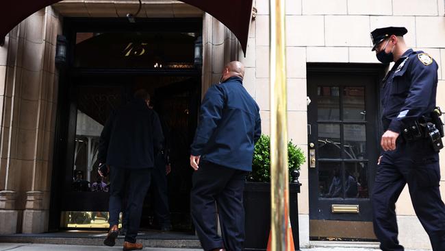 NYPD officers enter Rudy Giuliani’s apartment complex Picture: AFP.