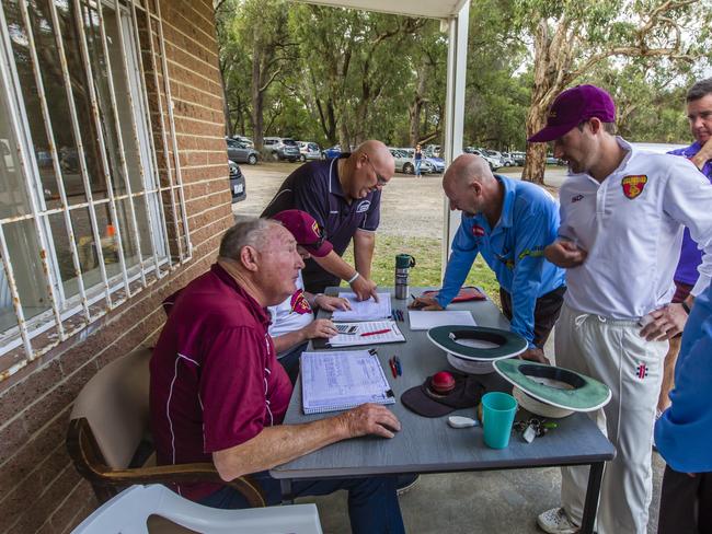 Scorers, umpires and players outside the pavilion at RM Hooper Oval in 2017. Picture: Valeriu Campan