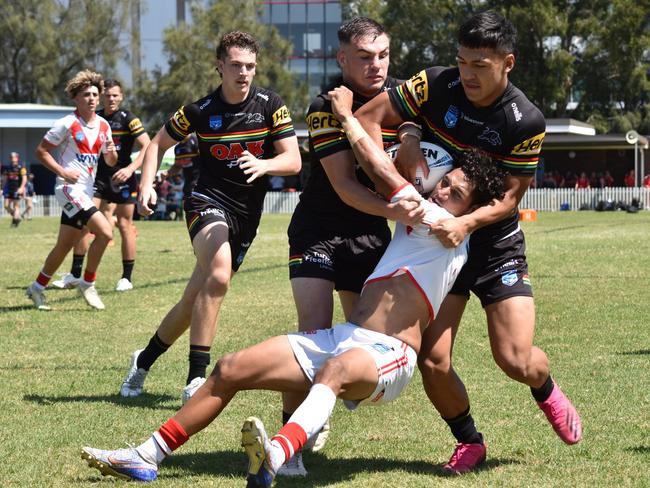 Ethan Hutchings (left) and Wilson De Courcey tackle Joven Gyemore in the SG Ball Cup. Picture: Sean Teuma/NewsLocal