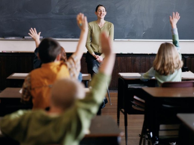 NEWS: Generic pic of a teacher standing at the blackboard while talking to students in a classroom.