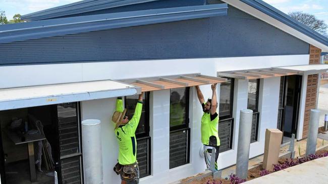 FINISHING TOUCH: Carpenters Izac Browning and Gavin Mead work hard for Gatton's Rooms Hotel to open next week. Picture: Francis Witsenhuysen