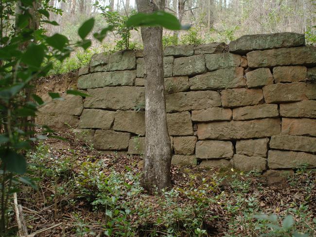 Remnants ... Stone wall along Simpson's Track, Mangrove Creek. The wall was built by convicts in the 1800s. Picture: Jim Trifyllis