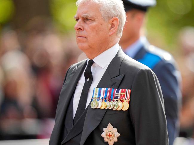 Britain's Prince Andrew, Duke of York follows the coffin of Queen Elizabeth II, adorned with a Royal Standard and the Imperial State Crown and pulled by a Gun Carriage of The King's Troop Royal Horse Artillery, during a procession from Buckingham Palace to the Palace of Westminster, in London on September 14, 2022. - Queen Elizabeth II will lie in state in Westminster Hall inside the Palace of Westminster, from Wednesday until a few hours before her funeral on Monday, with huge queues expected to file past her coffin to pay their respects. (Photo by Martin Meissner / POOL / AFP)