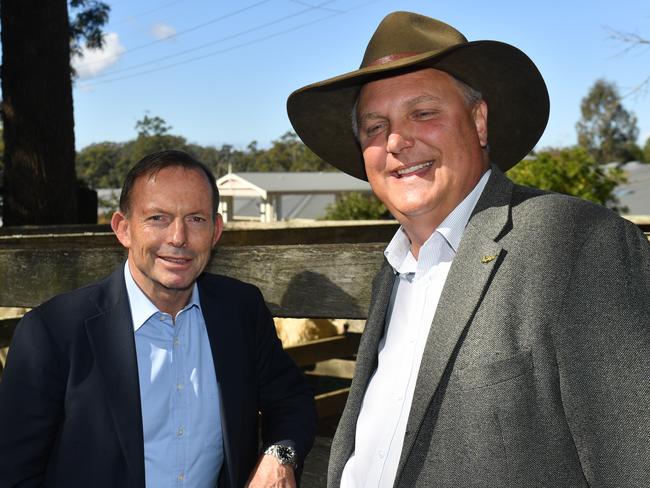 Former prime minister Tony Abbott and LNP candidate for Longman Trevor Ruthenberg at the Woodford cattle sales yards yesterday. Picture: AAP/Mick Tsikas