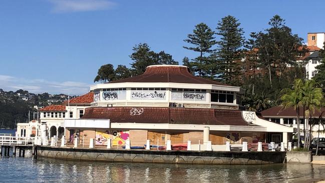 The boarded-up and graffiti damaged former Sea Life Aquarium building in Manly Cove, Manly, on Thursday. Picture: Jim O'Rourke