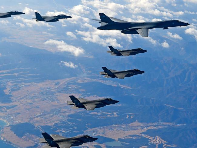 KOREAN PENINSULA, SOUTH KOREA - DECEMBER 06:  In this handout image provided by South Korean Defense Ministry, U.S. Air Force B-1B bomber (L), South Korea and U.S. fighter jets fly over the Korean Peninsula during the Vigilant air combat exercise (ACE) on December 6, 2017 in Korean Peninsula, South Korea. The largest-scale warplanes and military personnel take part in the annual joint exercise, which was scheduled before the North's latest missile test. North Korea fired a new intercontinental ballistic missile (ICBM) on November 29, believed to have shown capability to reach to the U.S. mainland.   (Photo by South Korean Defense Ministry via Getty Images) *** BESTPIX ***