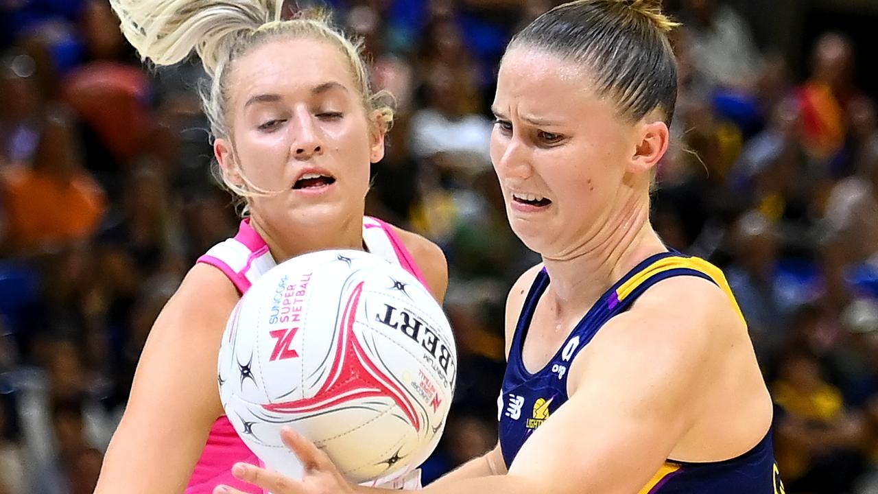 Mahalia Cassidy of the Lightning receives the ball under pressure from Adelaide’s Tayla Williams.