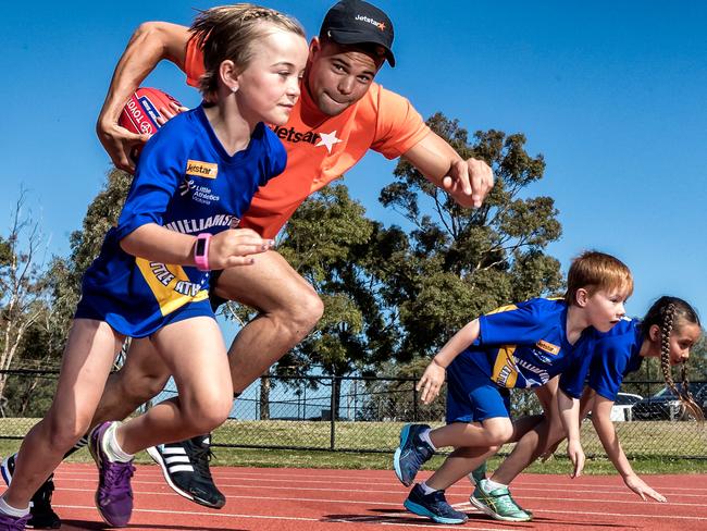 Western Bulldogs star Jason Johannisen with some of the Little Athletics youngsters at Williamstown. Picture: Mark Dadswell