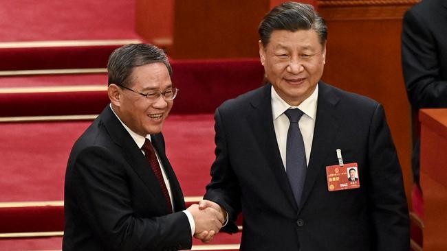 China's President Xi Jinping, right, shakes hands with Premier Li Qiang. Picture: Greg Baker/ Pool/AFP